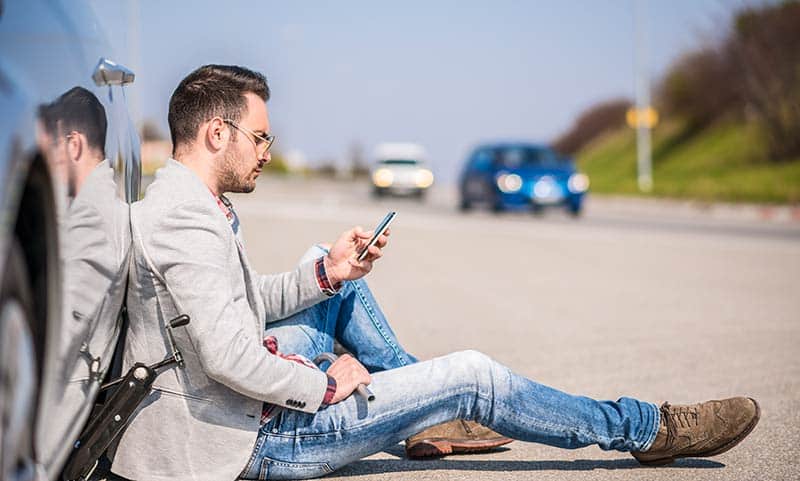 man stranded on the side of the road